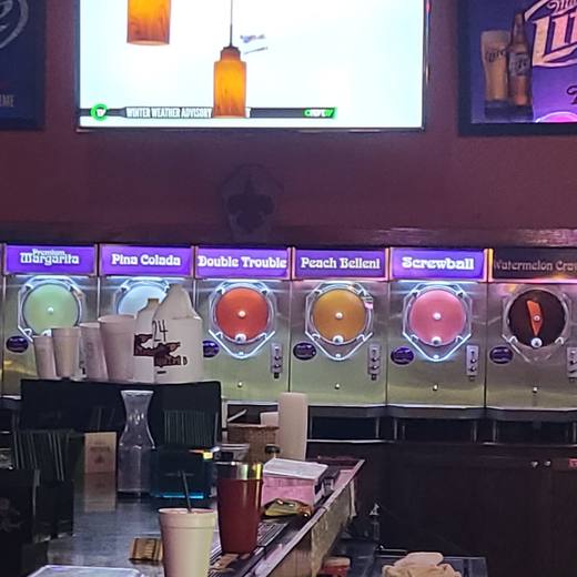 The frozen daiquiri machines under purple flavor labels