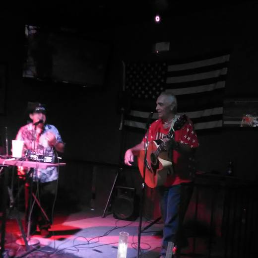 A keyboard and guitar duo playing the stage