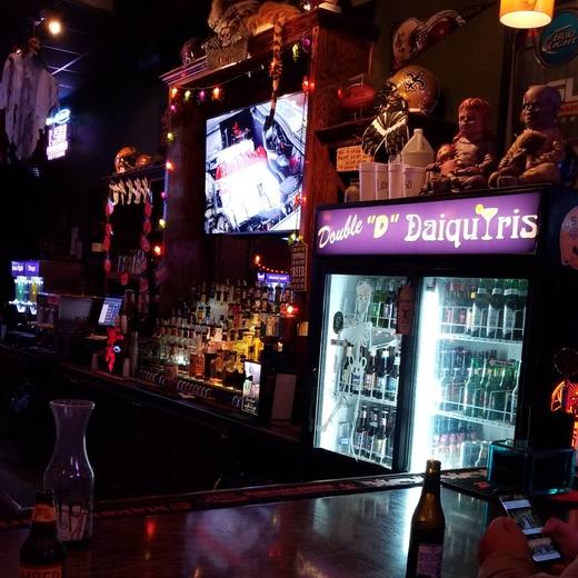 The bar at night with the Double D Daiquiris sign over the cooler