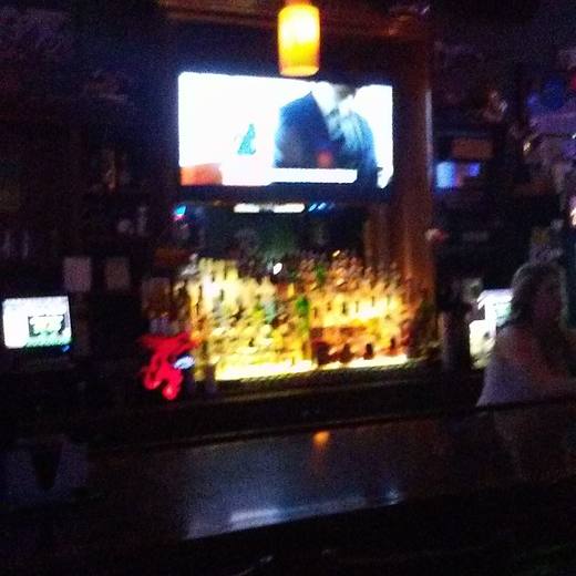 The back bar lit gold under the TV